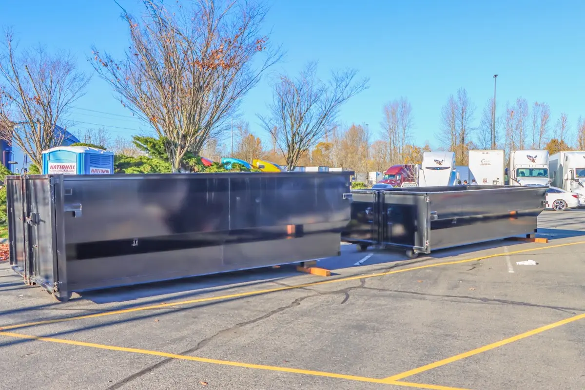 Professional dumpster rental service with roll-off container on residential driveway in Bayou Cane